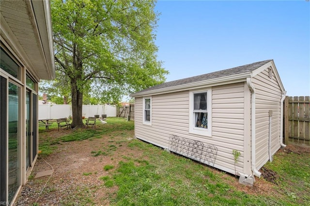 view of yard with a fenced backyard and an outbuilding