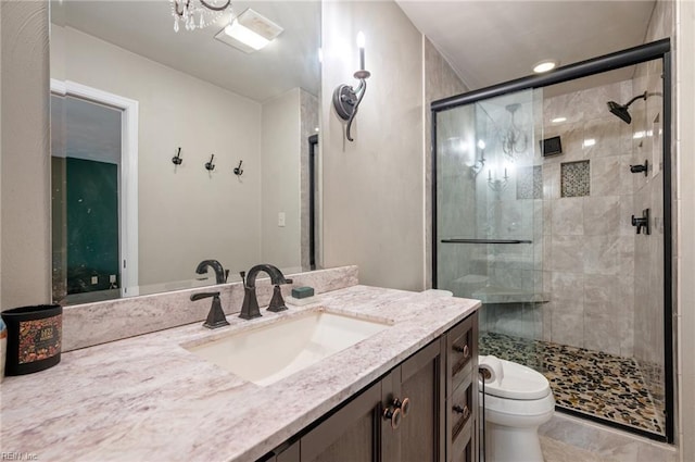 full bathroom with a shower stall, toilet, and vanity