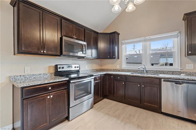 1405 Perry St, Chesapeake, VA 23324 - kitchen with light stone counters, dark brown cabinets, lofted ceiling, stainless steel appliances, and a sink