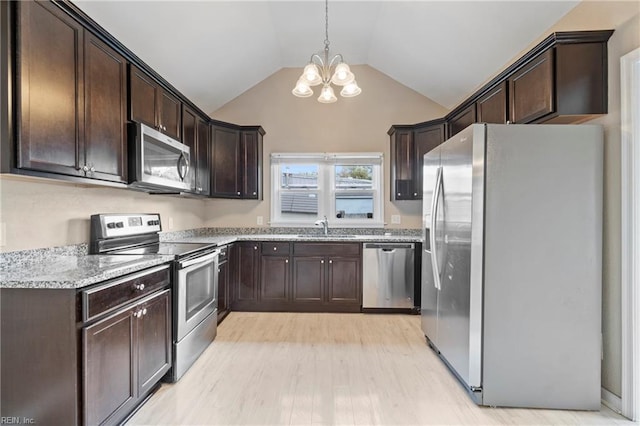1405 Perry St, Chesapeake, VA 23324 - kitchen featuring dark brown cabinetry, vaulted ceiling, a sink, stainless steel appliances, and a notable chandelier