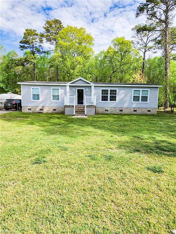view of front facade with a front lawn, a wooden deck, and crawl space