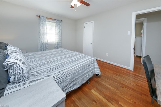 bedroom with wood finished floors, baseboards, and ceiling fan