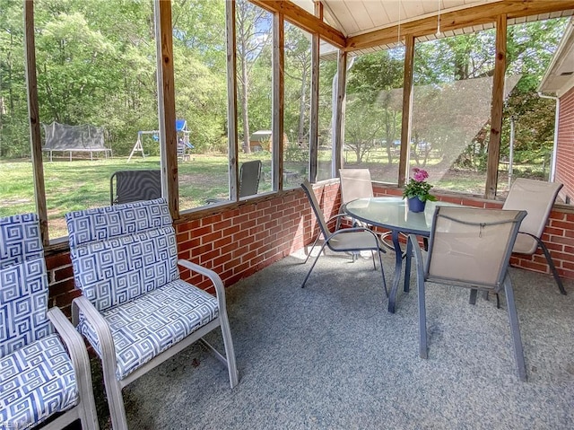 sunroom with outdoor dining area