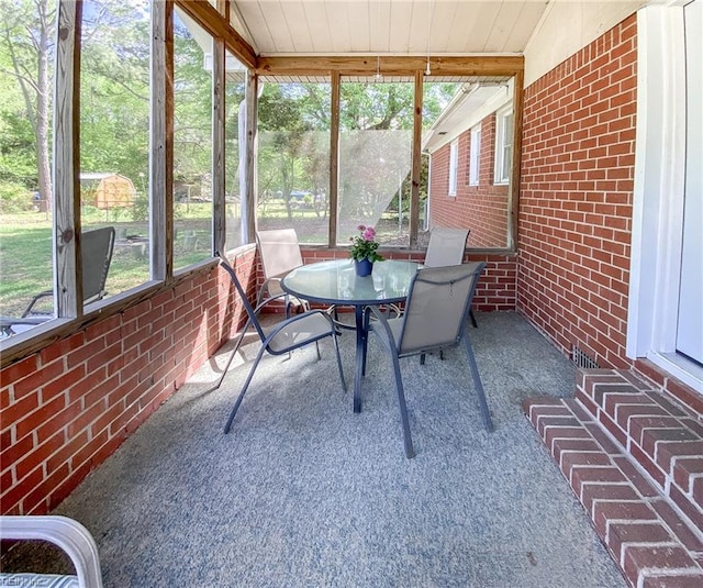 sunroom featuring outdoor dining space
