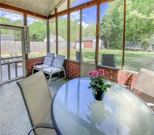 sunroom / solarium featuring outdoor dining area