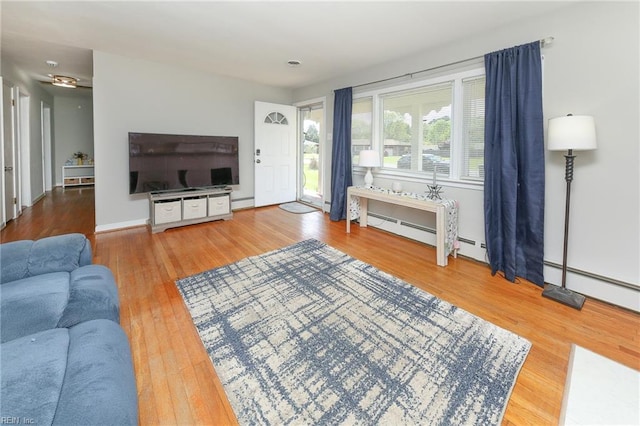 living area with a baseboard radiator and wood finished floors