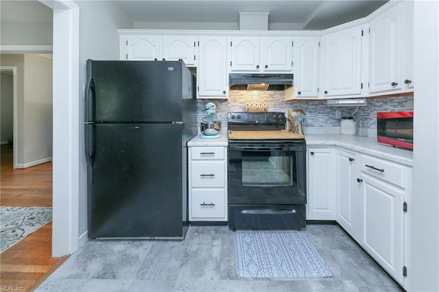 kitchen featuring black appliances, backsplash, under cabinet range hood, and light countertops