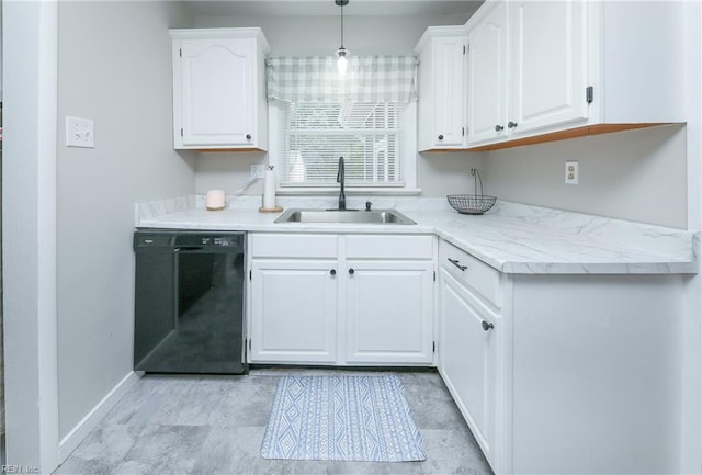 kitchen with hanging light fixtures, a sink, light countertops, white cabinets, and black dishwasher