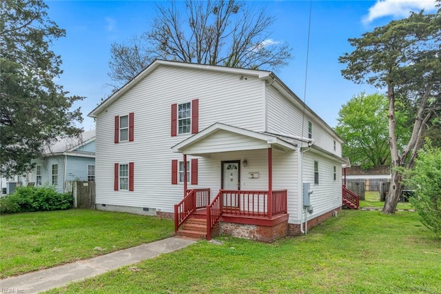 traditional home with a front lawn, crawl space, and a porch