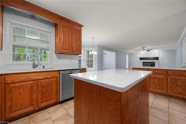 kitchen featuring a sink, crown molding, brown cabinetry, dishwasher, and a kitchen island