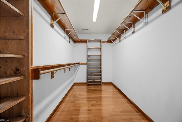 spacious closet with visible vents and wood finished floors