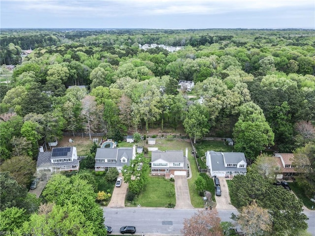 birds eye view of property featuring a residential view and a view of trees