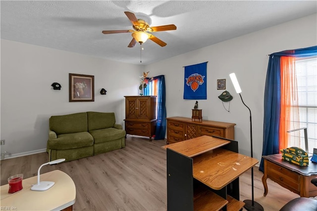 living area featuring ceiling fan and light wood-style floors