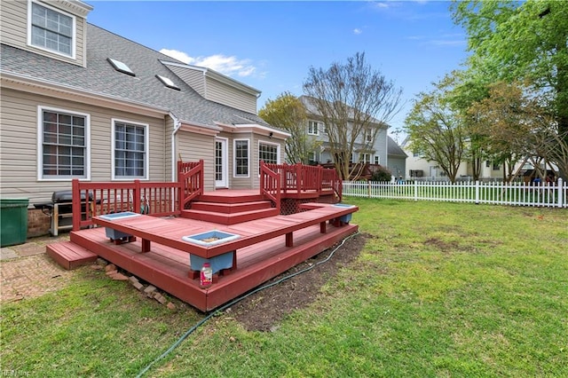 deck featuring a lawn, area for grilling, and fence