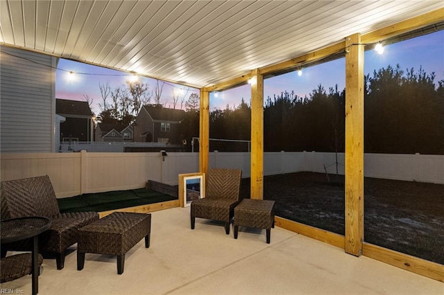 patio terrace at dusk with a fenced backyard