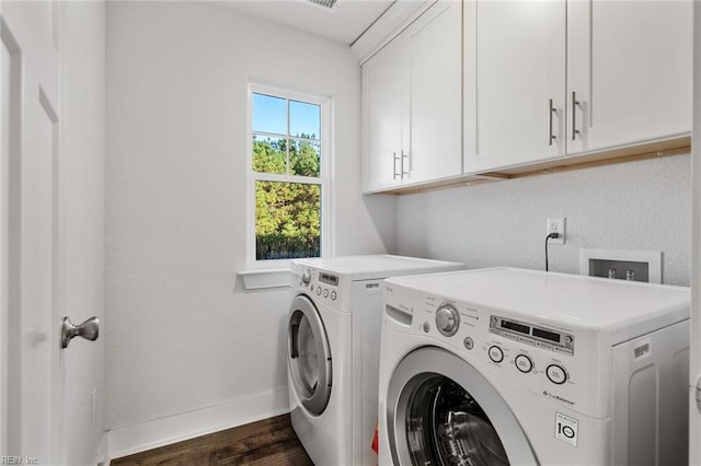 laundry room with washer and dryer, baseboards, cabinet space, and dark wood-style floors