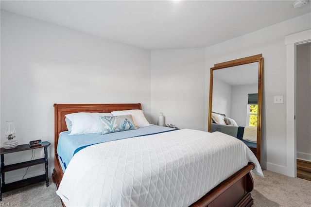 carpeted bedroom with baseboards