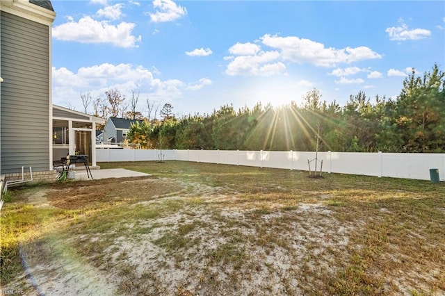 view of yard featuring fence and a patio area