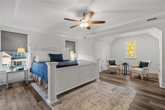 bedroom featuring visible vents, baseboards, a ceiling fan, wood finished floors, and crown molding
