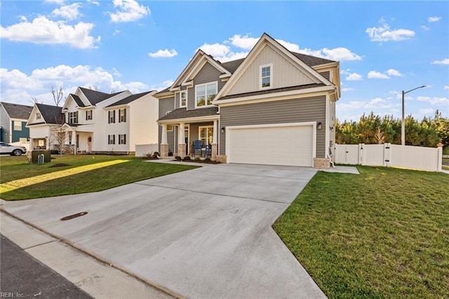 craftsman-style home featuring a gate, concrete driveway, board and batten siding, a front yard, and a garage