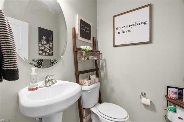 bathroom featuring toilet and a sink