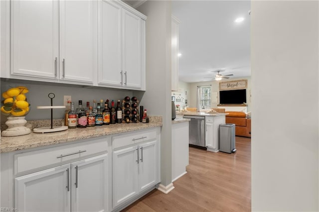 bar featuring stainless steel dishwasher, recessed lighting, a ceiling fan, and light wood-style flooring