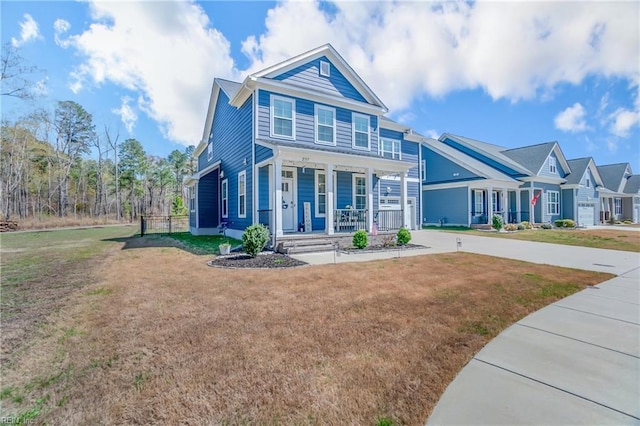 craftsman-style home with a front lawn and covered porch