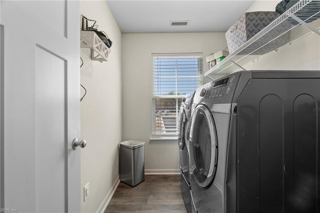 clothes washing area with visible vents, washer and clothes dryer, laundry area, and plenty of natural light