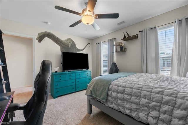 bedroom with carpet, visible vents, and ceiling fan