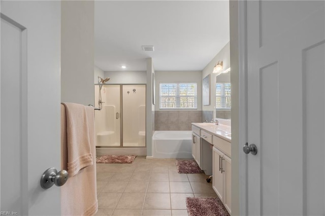 bathroom with a shower stall, tile patterned floors, a bath, vanity, and visible vents