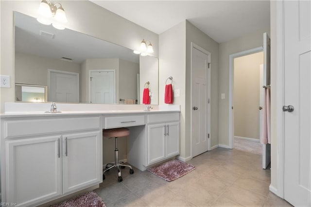full bathroom featuring tile patterned floors, double vanity, visible vents, a sink, and baseboards