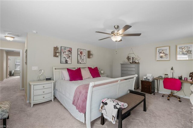 bedroom with light colored carpet, ceiling fan, baseboards, and visible vents