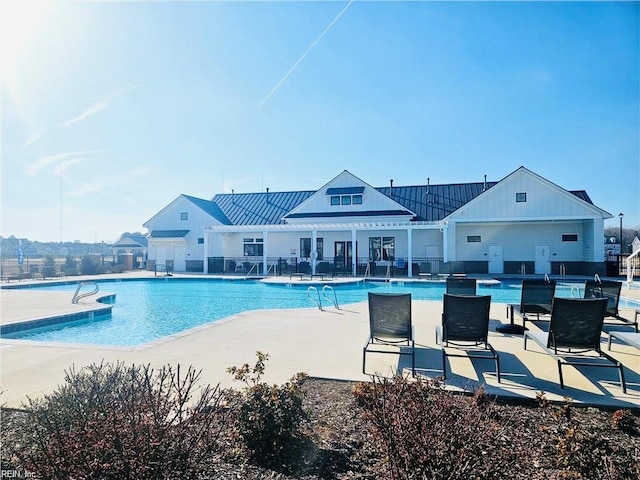pool featuring fence and a patio area
