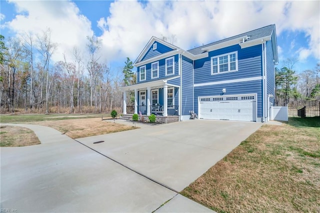 view of front facade featuring a porch, concrete driveway, fence, a garage, and a front yard