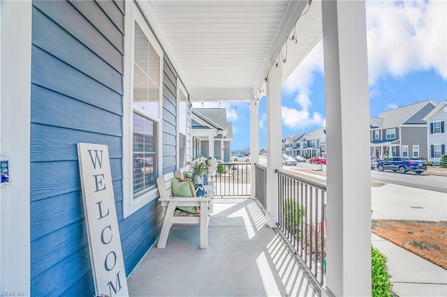 balcony featuring a porch and a residential view