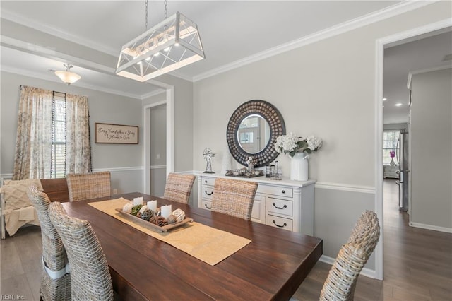 dining area featuring plenty of natural light, ornamental molding, baseboards, and wood finished floors
