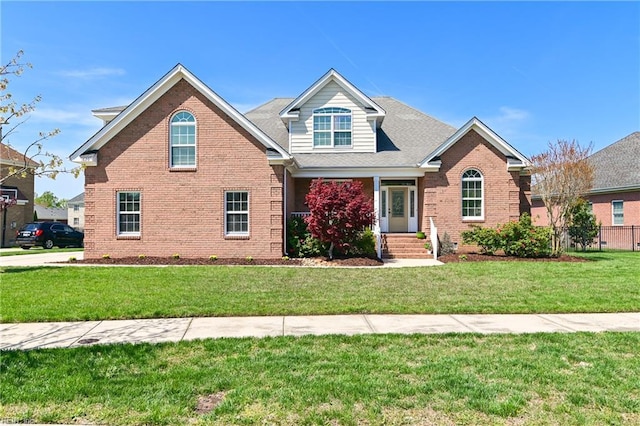 craftsman inspired home with brick siding and a front yard