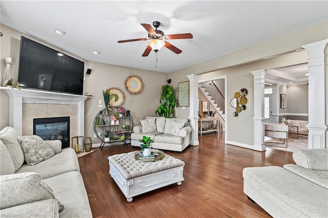 living area with stairway, a ceiling fan, decorative columns, a fireplace, and recessed lighting