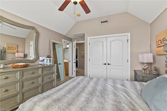 bedroom with lofted ceiling, visible vents, a closet, and ceiling fan