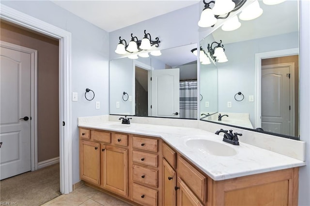 bathroom with tile patterned flooring, a sink, and double vanity