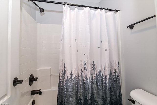 full bathroom featuring shower / bath combo with shower curtain and toilet