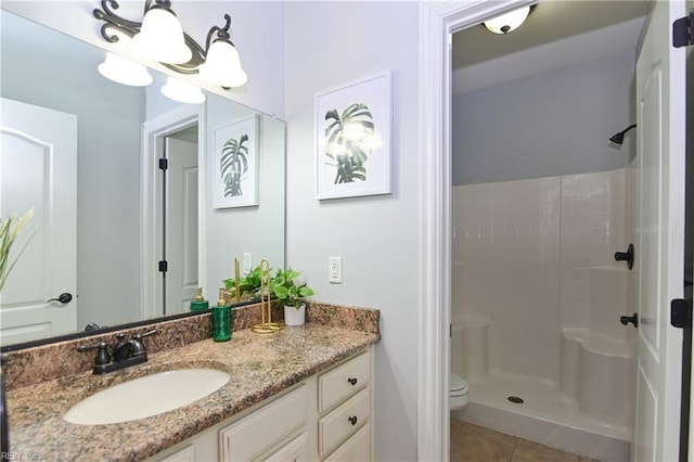 bathroom with walk in shower, tile patterned floors, vanity, and toilet