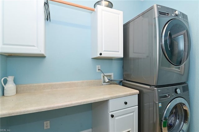 laundry room with cabinet space and stacked washer and dryer
