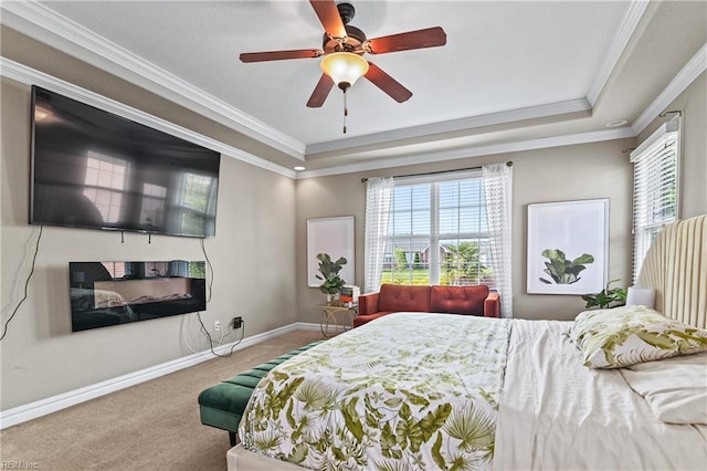 bedroom featuring baseboards, carpet flooring, multiple windows, and a raised ceiling