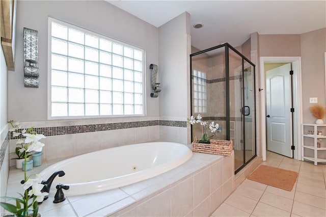 full bath featuring a bath, a shower stall, a wealth of natural light, and tile patterned floors