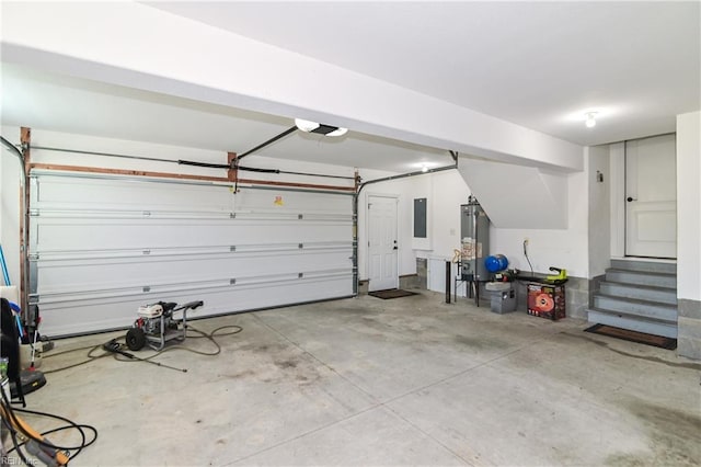 garage featuring gas water heater, electric panel, and a garage door opener