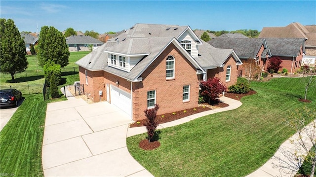 traditional-style house featuring concrete driveway, a front lawn, fence, a garage, and brick siding