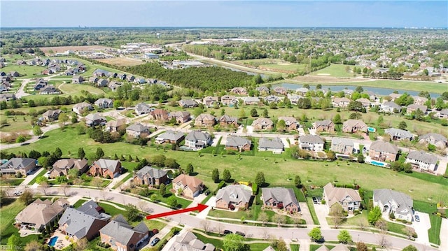 birds eye view of property featuring a residential view and a water view