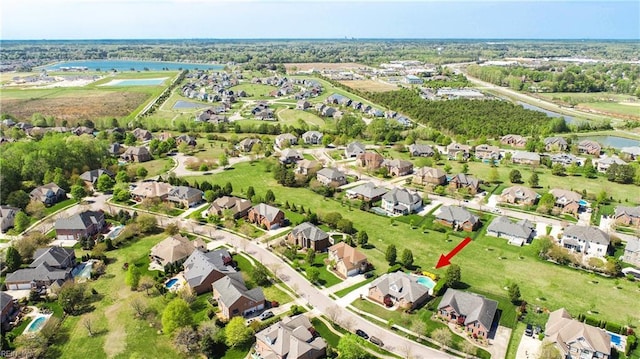 drone / aerial view with a residential view and a water view