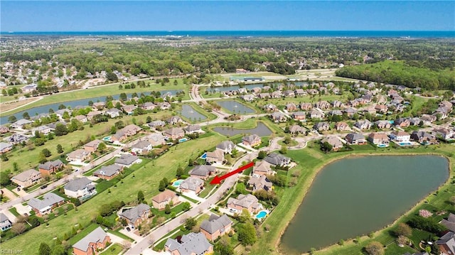 bird's eye view featuring a residential view and a water view